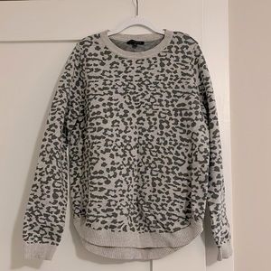 Crewneck gray on gray leopard print sweater with ribbed edge detail.